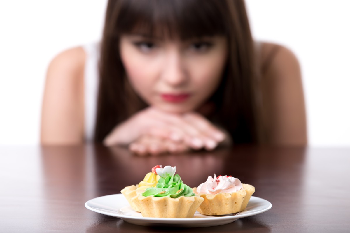 Dieting woman craving for cake