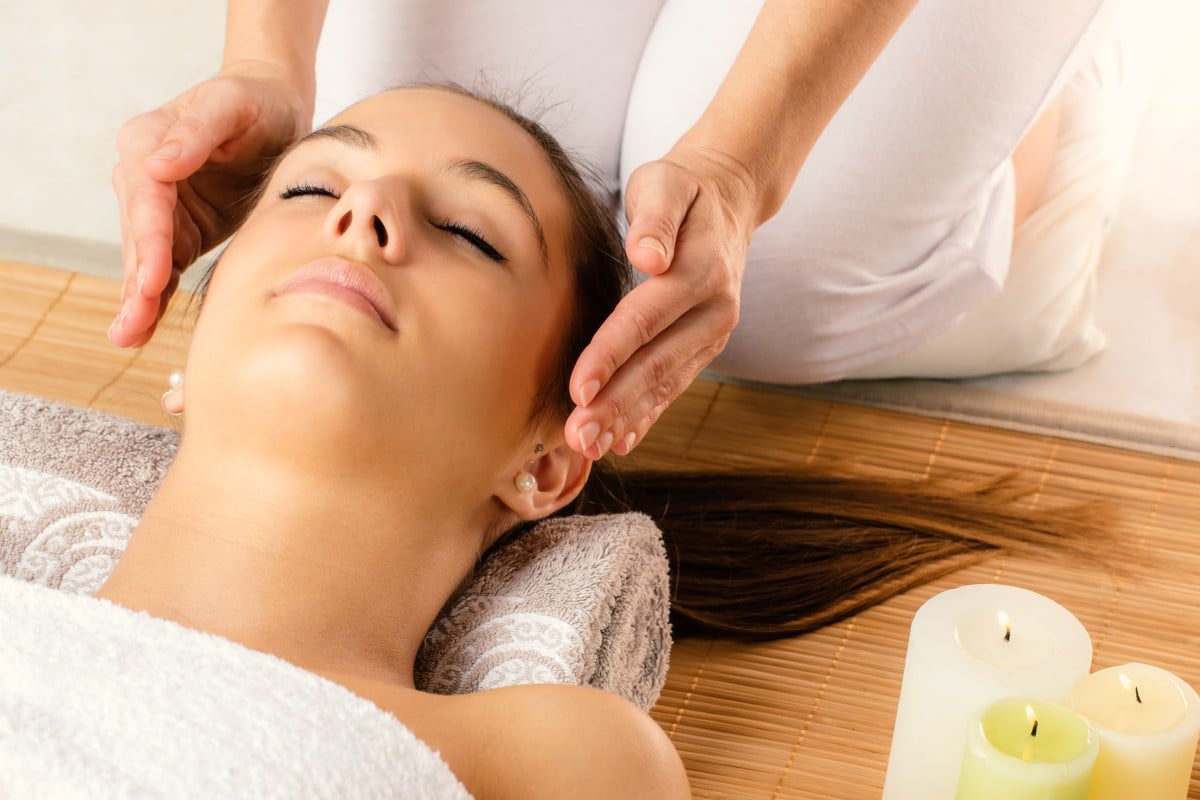 Face shot of woman at reiki session.
