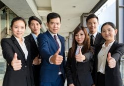 Business people showing thumb up gesture