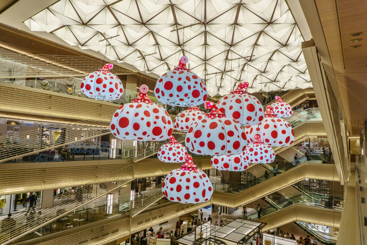 Tokyo , japan - july 26, 2017 : models of pumpkins by kusama yayoi hang from the ceiling of ginzasix shopping center.