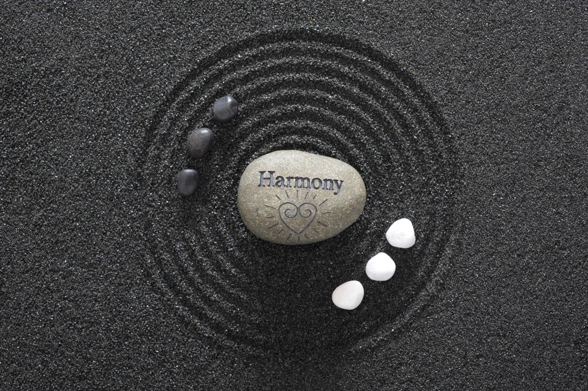 Japanese zen garden with yin and yang stones and harmony in text