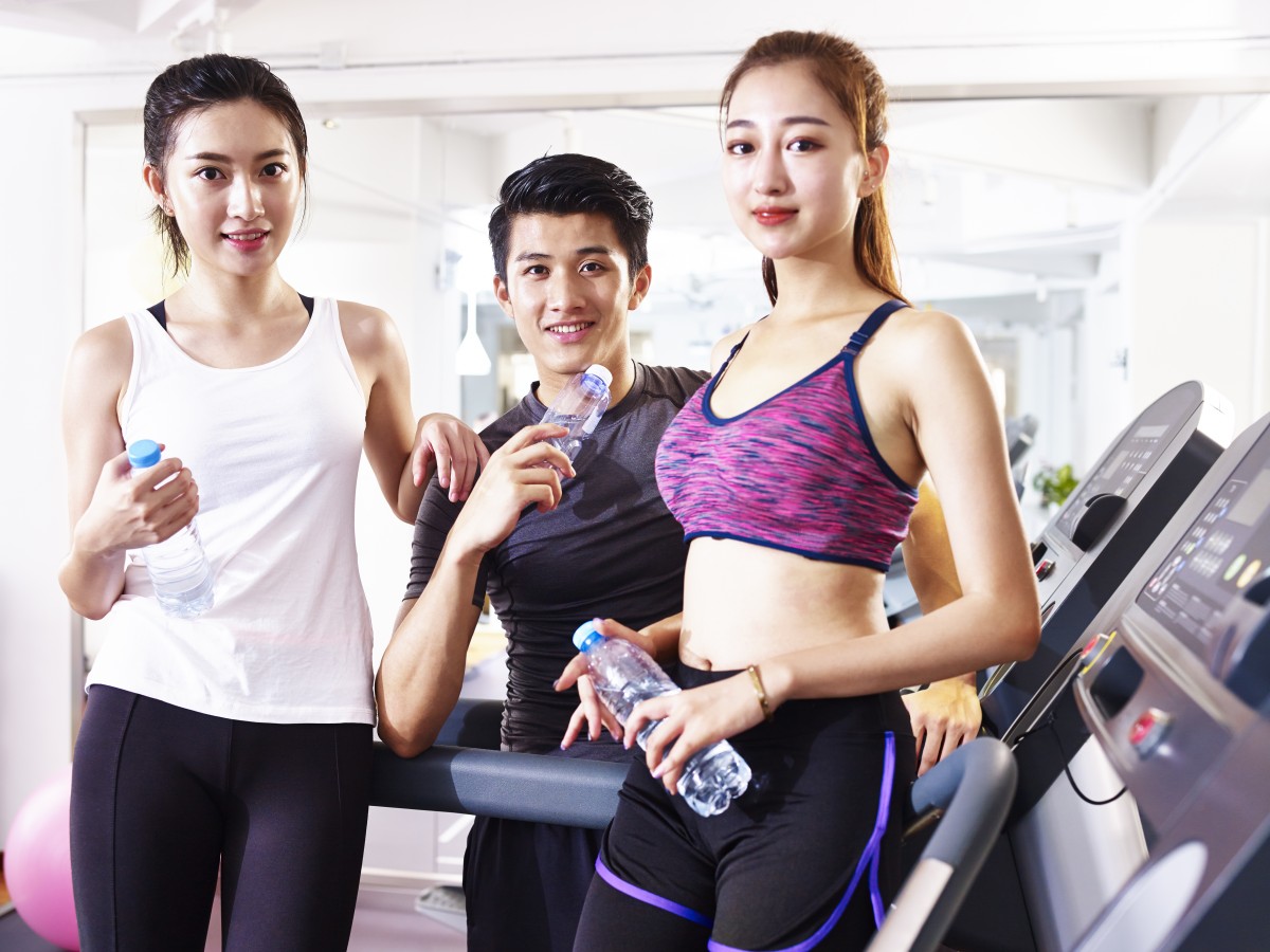 Portrait of three young asian people in gym